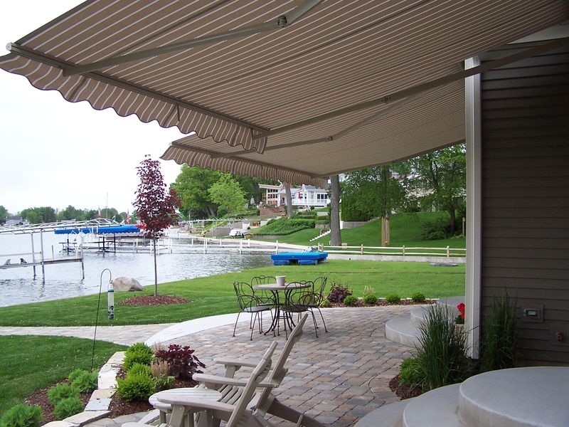 Retractable awning over lakeside patio